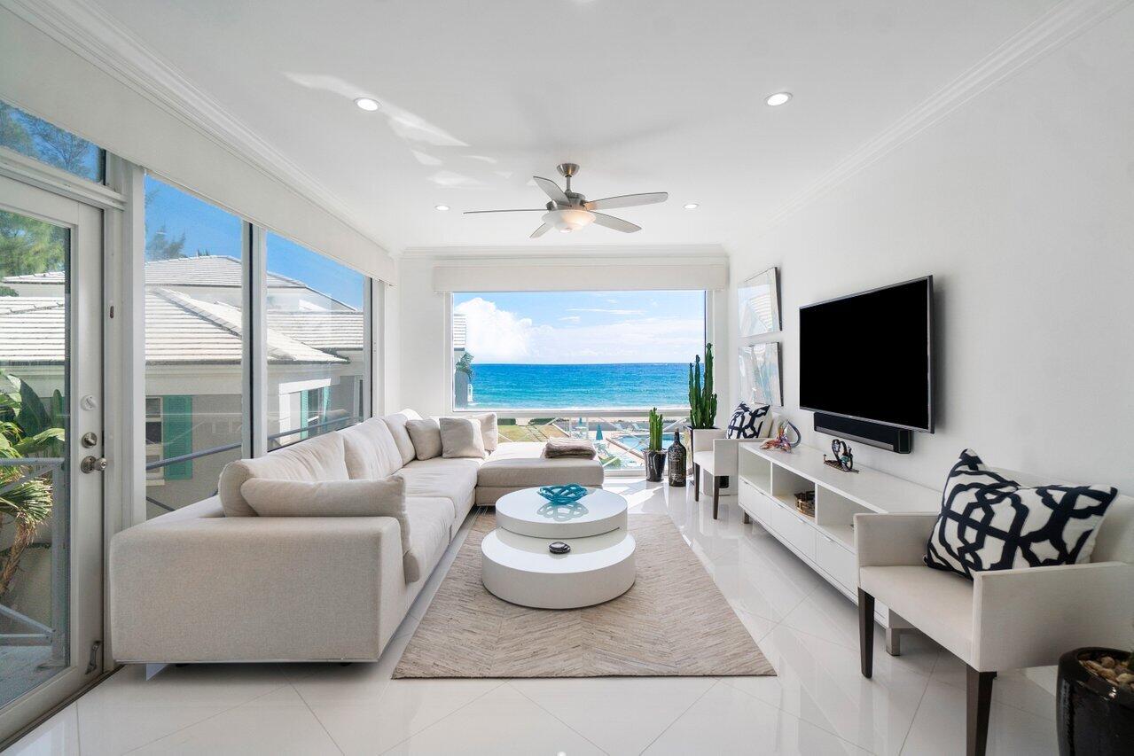 2665 North Ocean Boulevard, Unit 3 Gulf Stream, FL 33483 - Photo 2 of 50 a living room with furniture and a flat screen tv
