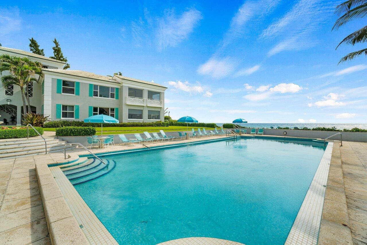 2665 North Ocean Boulevard, Unit 3 Gulf Stream, FL 33483 - Photo 15 of 50 a view of swimming pool with outdoor seating and lake view