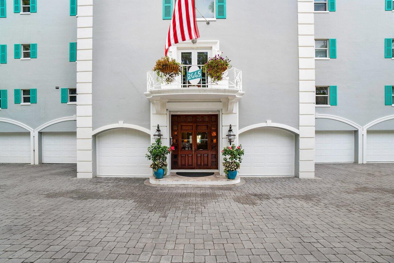 2665 North Ocean Boulevard, Unit 3 Gulf Stream, FL 33483 - Photo 19 of 50 a view of a livingroom with a fireplace and chair