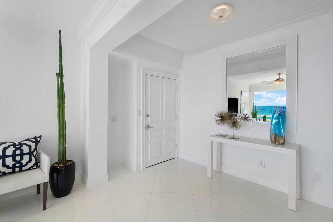 2665 North Ocean Boulevard, Unit 3 Gulf Stream, FL 33483 - Photo 20 of 50 a living room with furniture and a flat screen tv