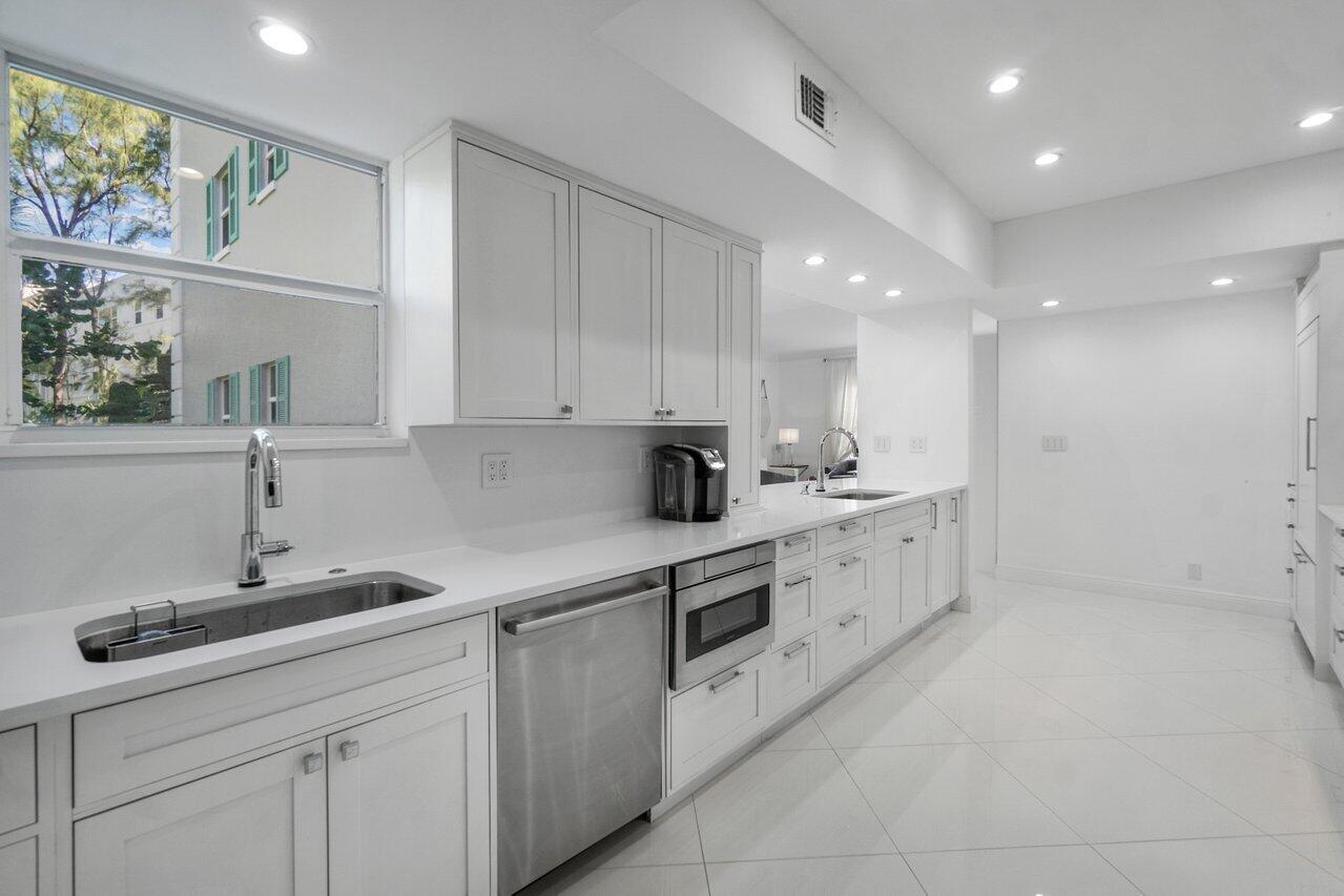 2665 North Ocean Boulevard, Unit 3 Gulf Stream, FL 33483 - Photo 26 of 50 a kitchen with sink cabinets and window