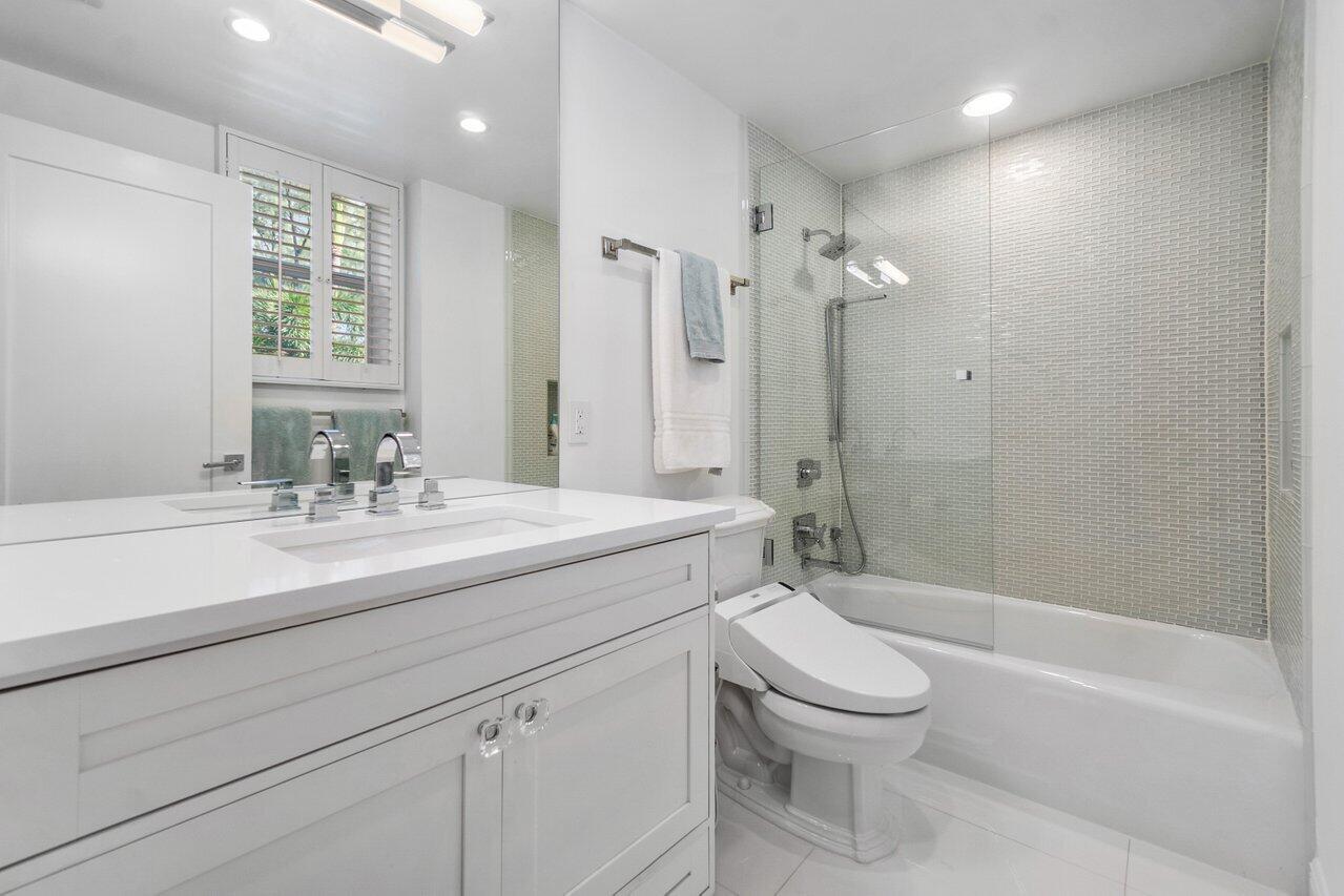 2665 North Ocean Boulevard, Unit 3 Gulf Stream, FL 33483 - Photo 32 of 50 a bathroom with a sink a toilet and shower