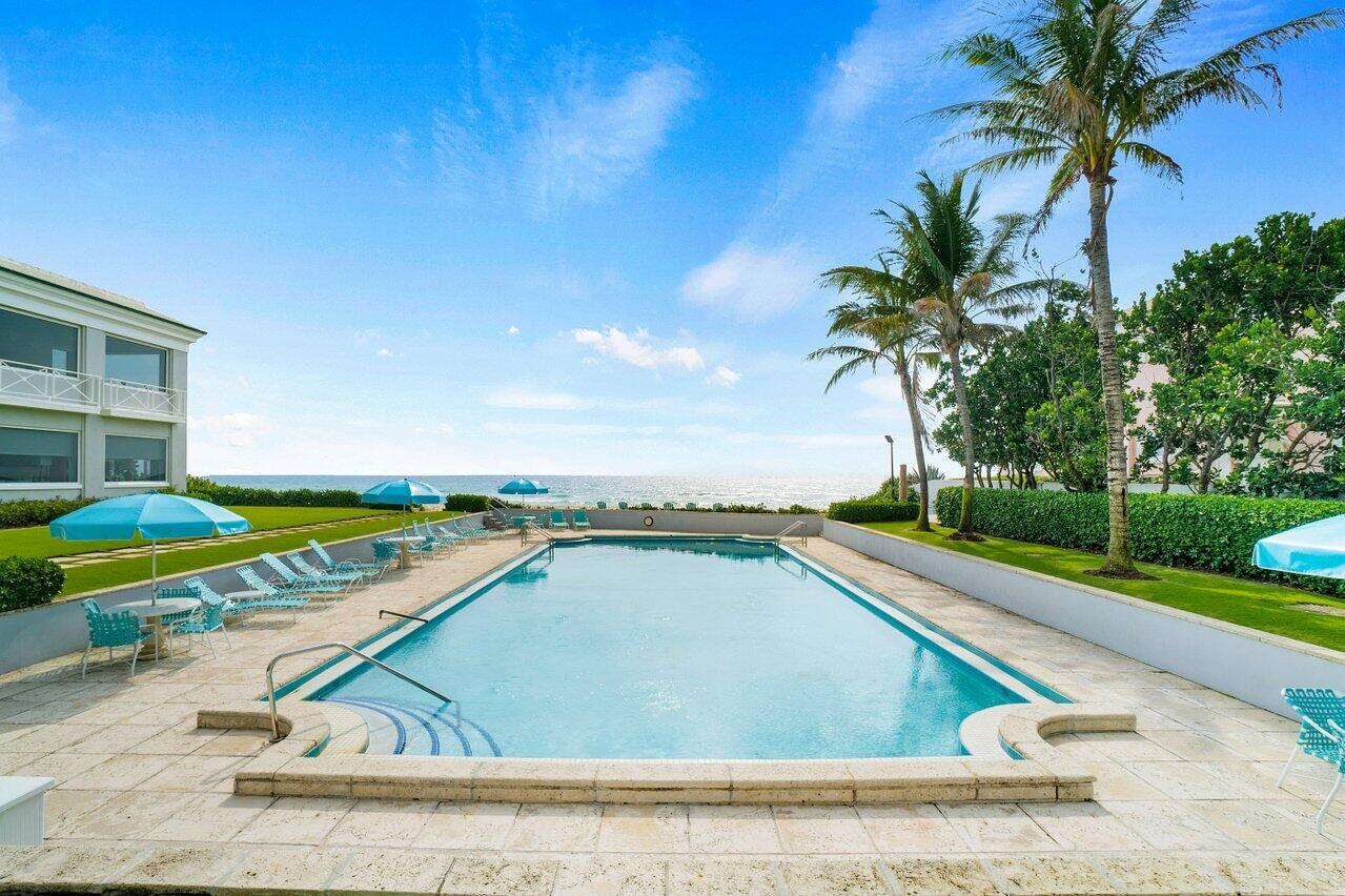 2665 North Ocean Boulevard, Unit 3 Gulf Stream, FL 33483 - Photo 37 of 50 a view of a swimming pool with an outdoor space and seating area