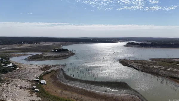 a large bedroom with bed and a large window