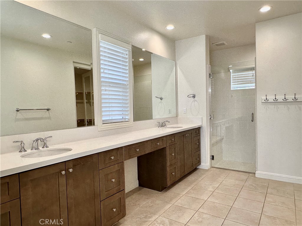 158 Bryce Run Lake Forest, CA 92630 - Photo 12 of 27 a spacious bathroom with a double vanity sink a mirror and a shower