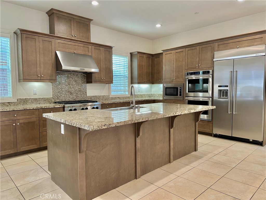 158 Bryce Run Lake Forest, CA 92630 - Photo 2 of 27 a kitchen with stainless steel appliances granite countertop a sink stove and refrigerator