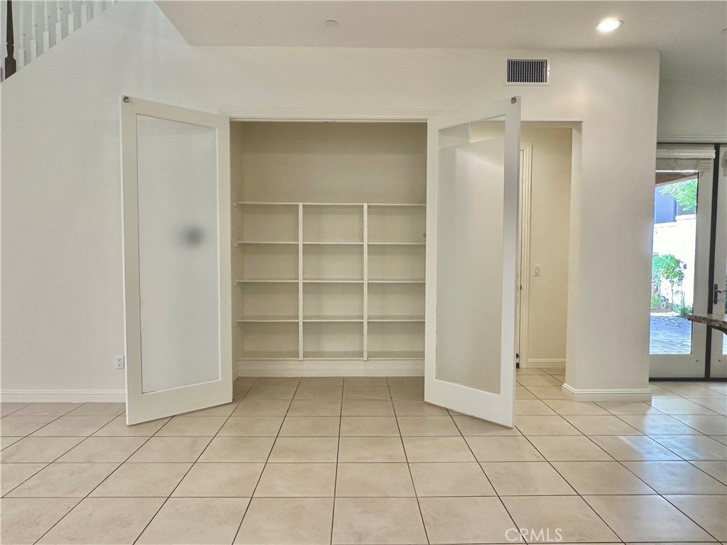 158 Bryce Run Lake Forest, CA 92630 - Photo 4 of 27 an empty room with cabinet and mirrors