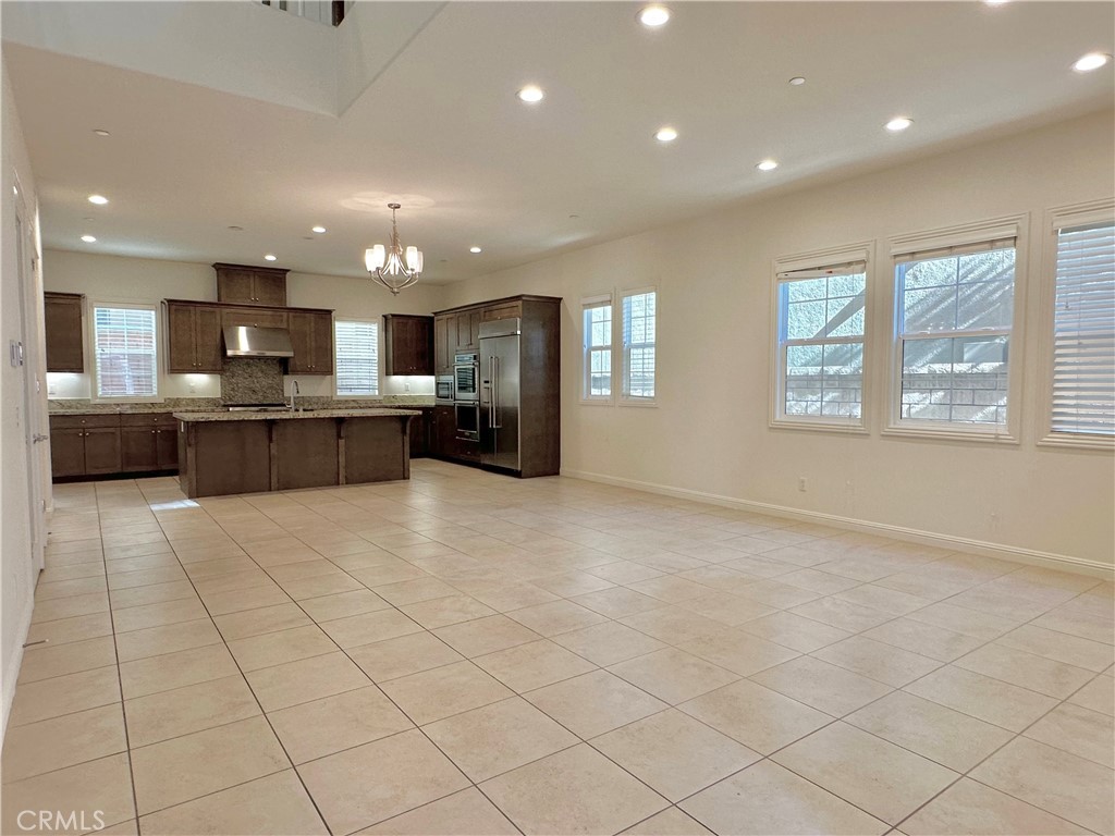 158 Bryce Run Lake Forest, CA 92630 - Photo 5 of 27 a view of kitchen with kitchen island granite countertop lots of white cabinets stainless steel appliances a sink and a counter top space