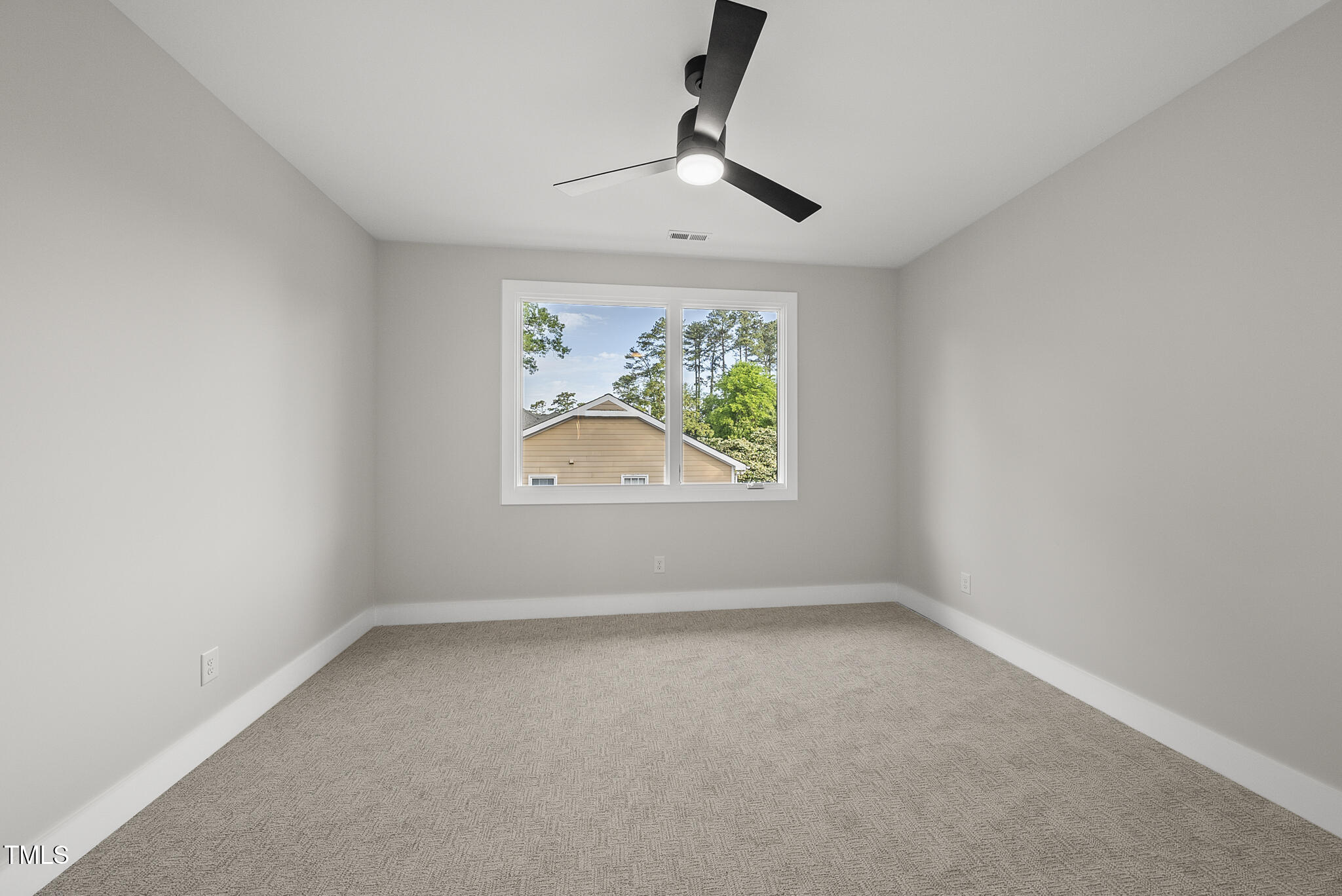 662 Manchester Drive Raleigh, NC 27609 - Photo 35 of 46 an empty room with windows and a ceiling fan