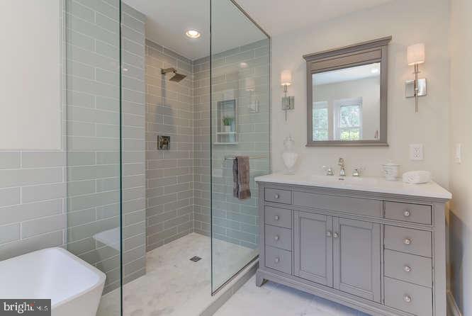 110 Guernsey Road Swarthmore, PA 19081 - Photo 23 of 34 Walk in frameless shower & attractive gray cabinet