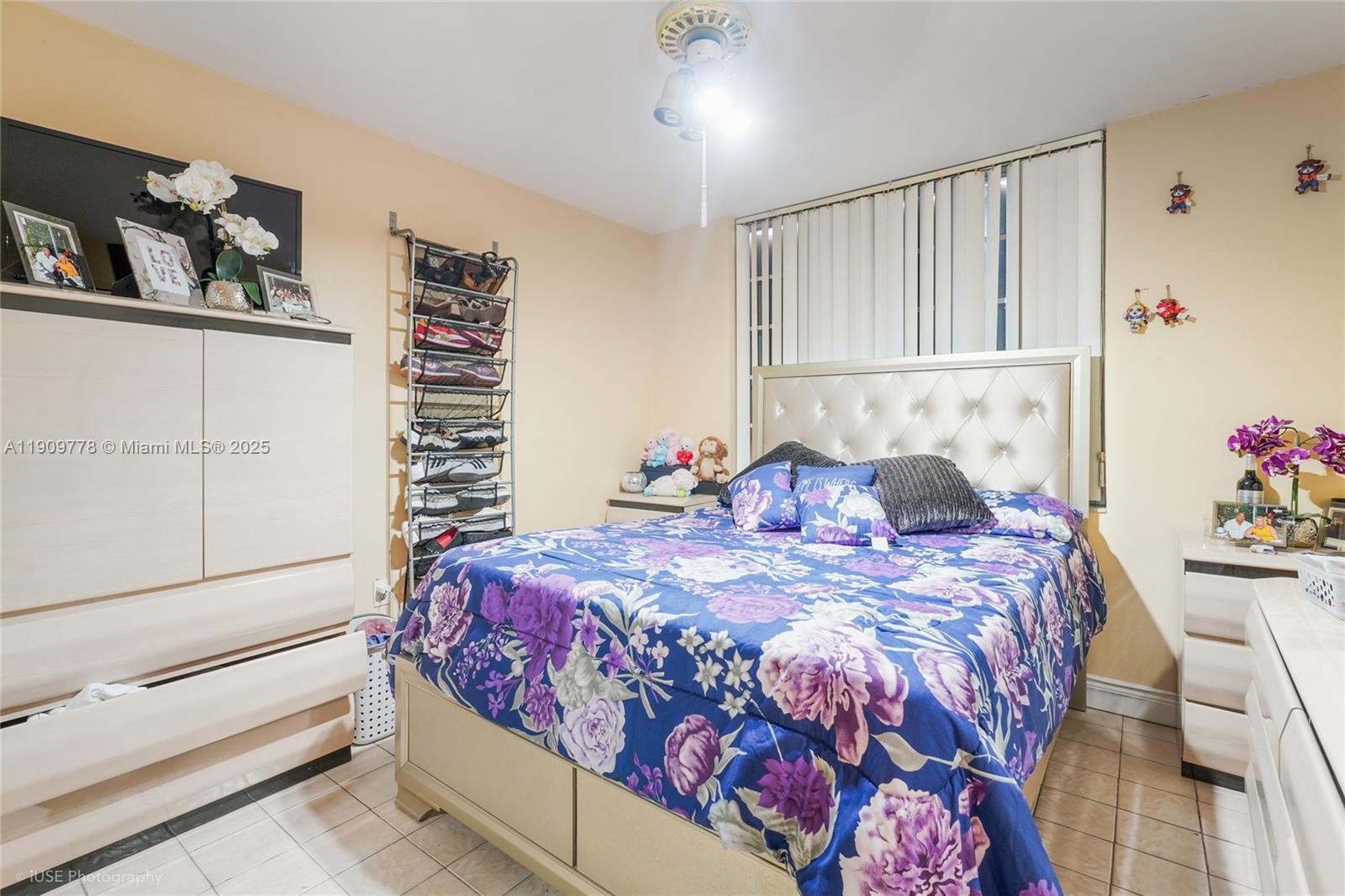 3900 West 11 Avenue, Unit 55 Hialeah, FL 33012 - Photo 6 of 12 a bed sitting in a bedroom next to a window with a book shelf