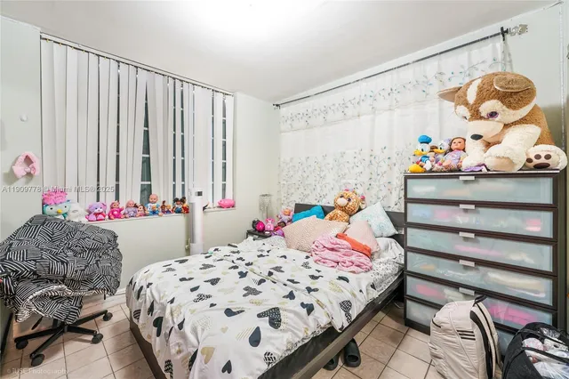 a bedroom with bed and a window