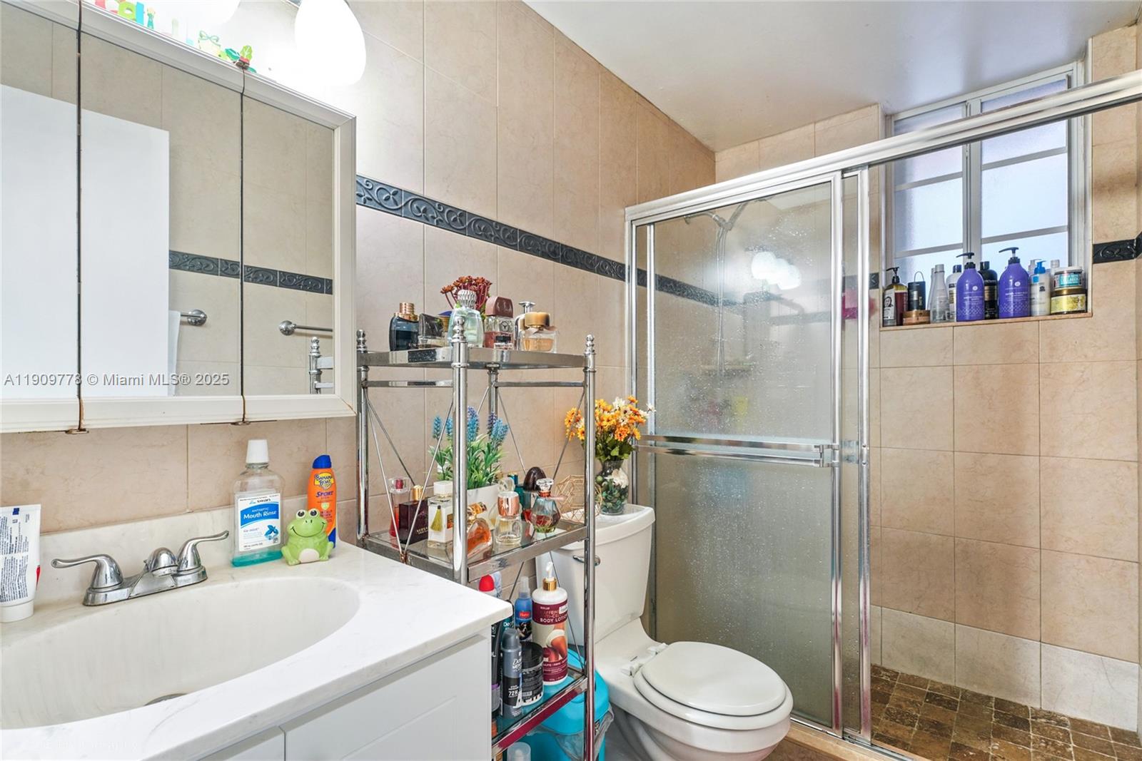 3900 West 11 Avenue, Unit 55 Hialeah, FL 33012 - Photo 8 of 12 a bathroom with a sink a toilet and shower