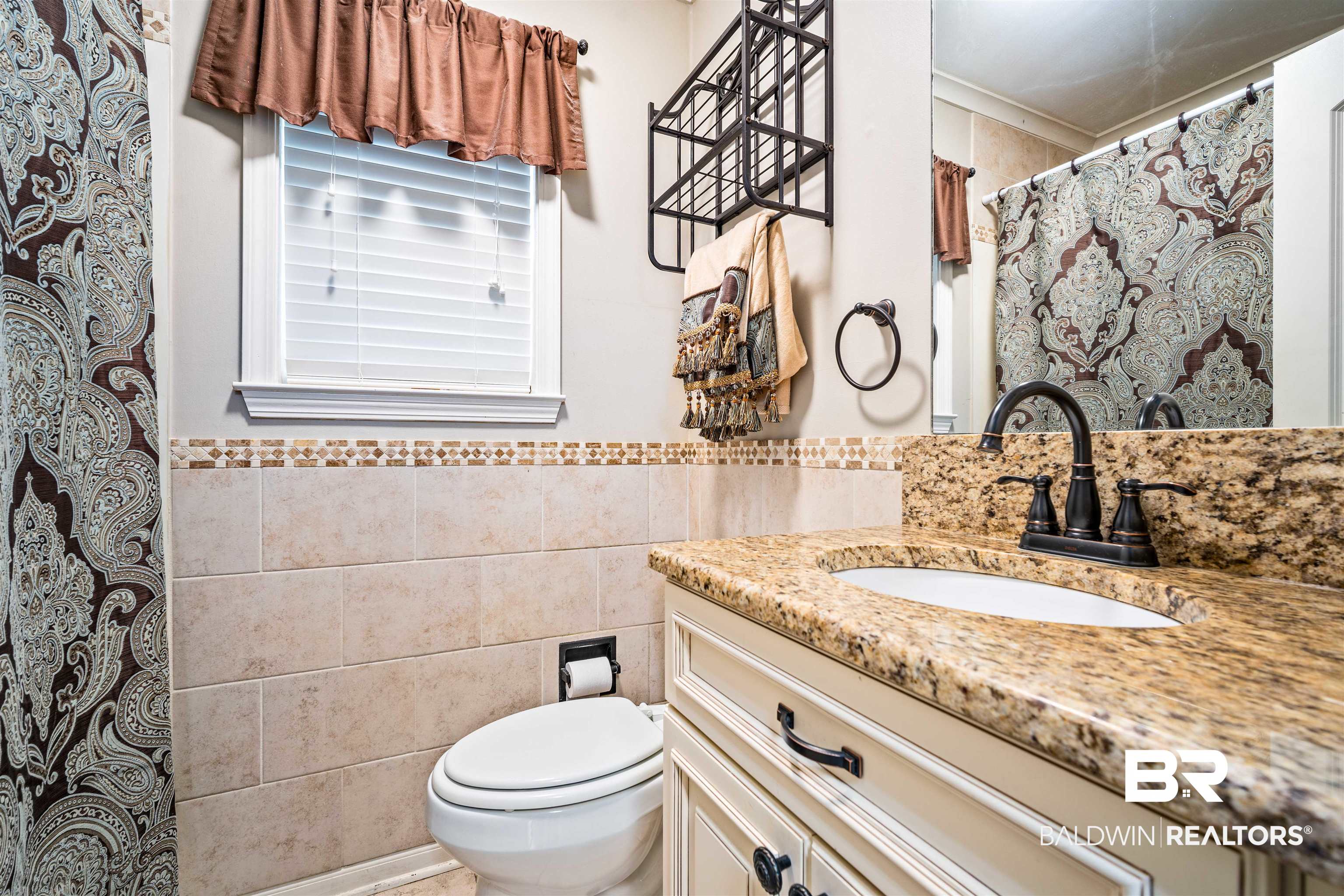 627 Spanish Main Spanish Fort, AL 36527 - Photo 28 of 39 Full bathroom with tile walls, toilet, vanity, and wainscoting