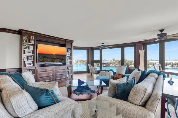 a living room with furniture and a floor to ceiling window