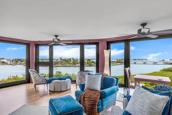 a balcony with furniture and a floor to ceiling window