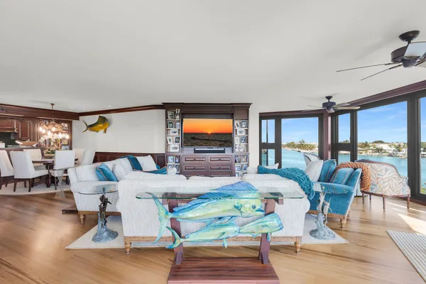 a living room with furniture a large window and a flat screen tv