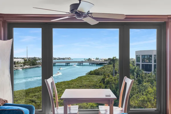 a living room with furniture tv and a floor to ceiling window