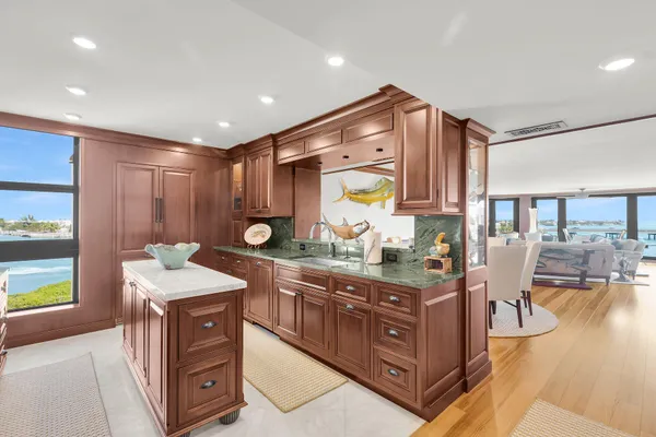 a kitchen with stainless steel appliances granite countertop a sink and a stove