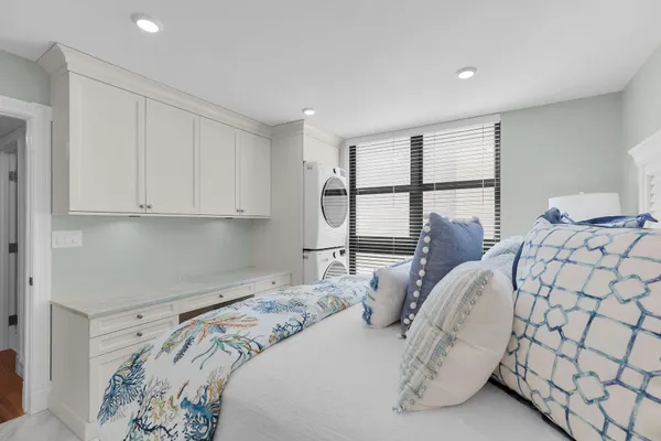 a spacious bedroom with a bed and a cabinets