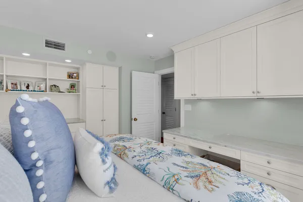 a bathroom with a granite countertop sink a toilet a mirror and shower