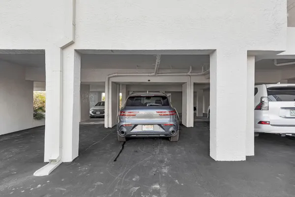 a view of a terrace with lawn chairs