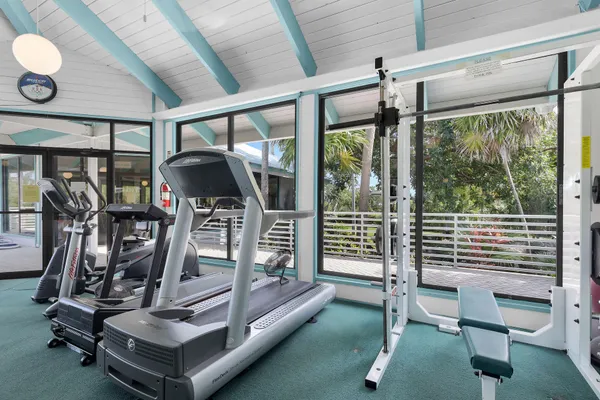a view of a lake with couches and wooden fence