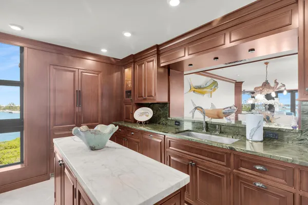 a kitchen with a sink a stove cabinets and wooden floor