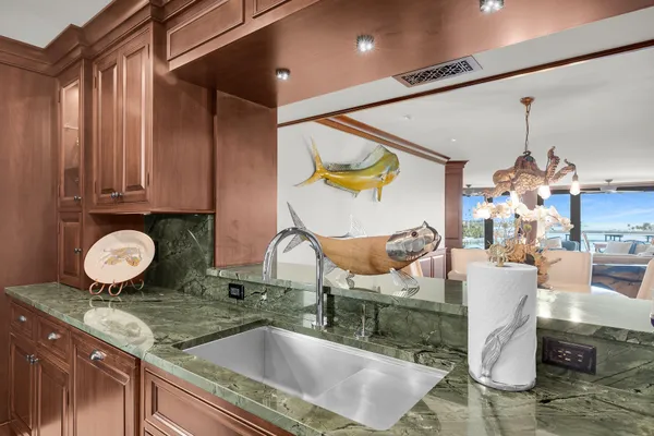 a kitchen with granite countertop a sink and a stove