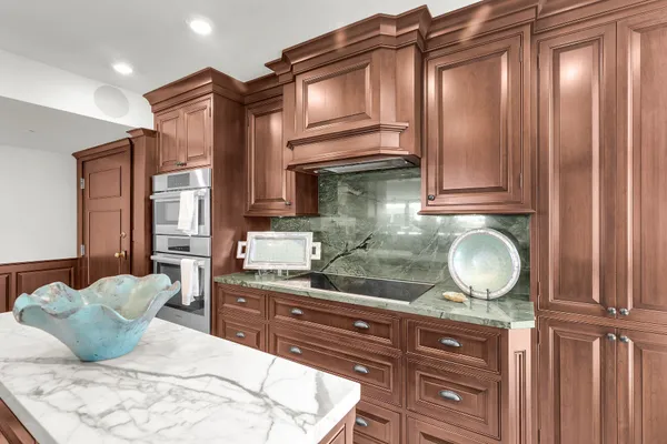 a dining room with furniture large windows and wooden floor