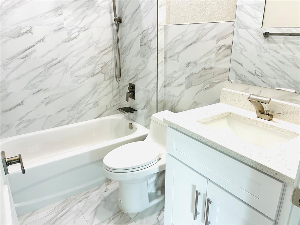 98 Wheatfield Drive, Unit B Palm Coast, FL 32164 - Photo 12 of 21 a bathroom with a sink toilet and shower