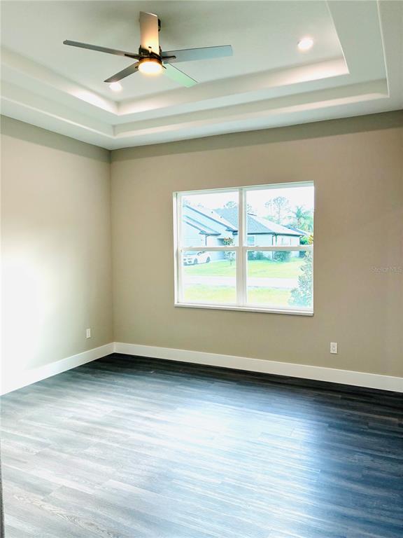 98 Wheatfield Drive, Unit B Palm Coast, FL 32164 - Photo 15 of 21 an empty room with wooden floor and windows