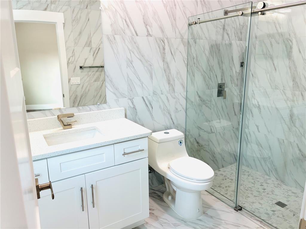 98 Wheatfield Drive, Unit B Palm Coast, FL 32164 - Photo 17 of 21 a bathroom with a sink a toilet and shower