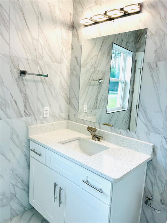 98 Wheatfield Drive, Unit B Palm Coast, FL 32164 - Photo 19 of 21 a bathroom with a sink and a mirror