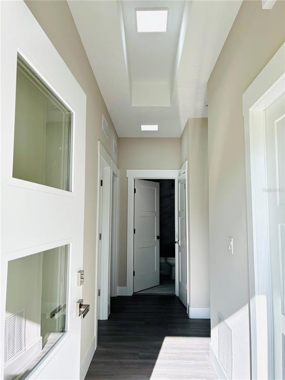 98 Wheatfield Drive, Unit B Palm Coast, FL 32164 - Photo 3 of 21 a view of a hallway with wooden floor and closet