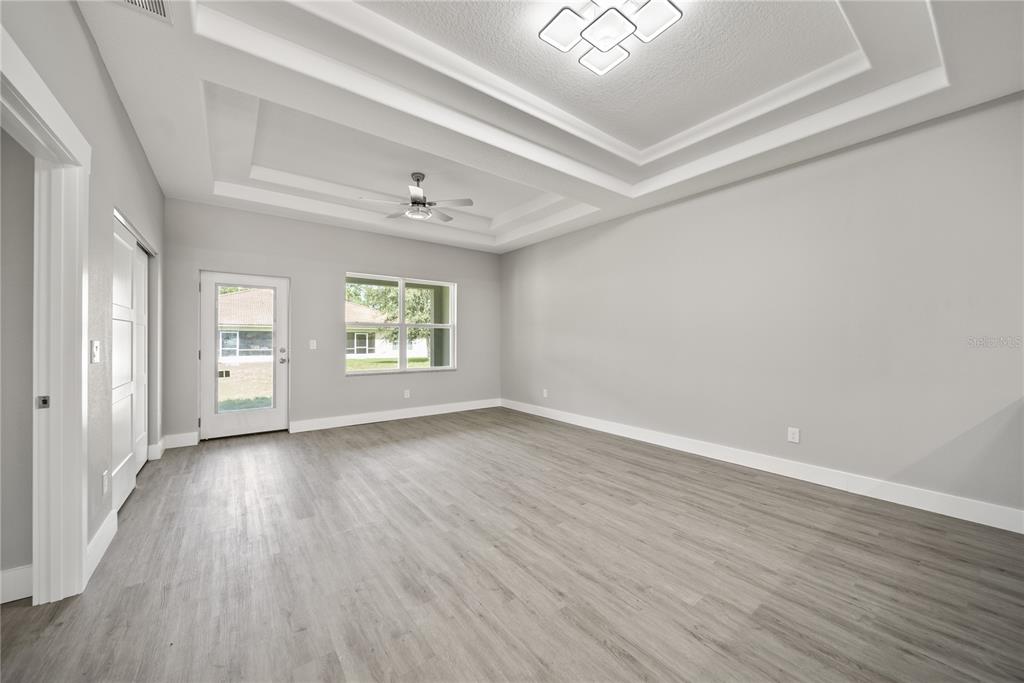 98 Wheatfield Drive, Unit B Palm Coast, FL 32164 - Photo 5 of 21 wooden floor in an empty room with a window