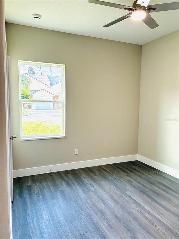 98 Wheatfield Drive, Unit B Palm Coast, FL 32164 - Photo 9 of 21 an empty room with wooden floor and windows