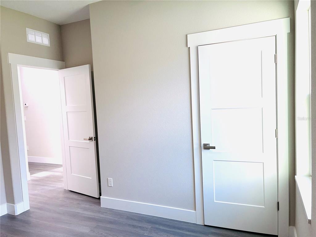 98 Wheatfield Drive, Unit B Palm Coast, FL 32164 - Photo 10 of 21 a view of an empty room with wooden floor