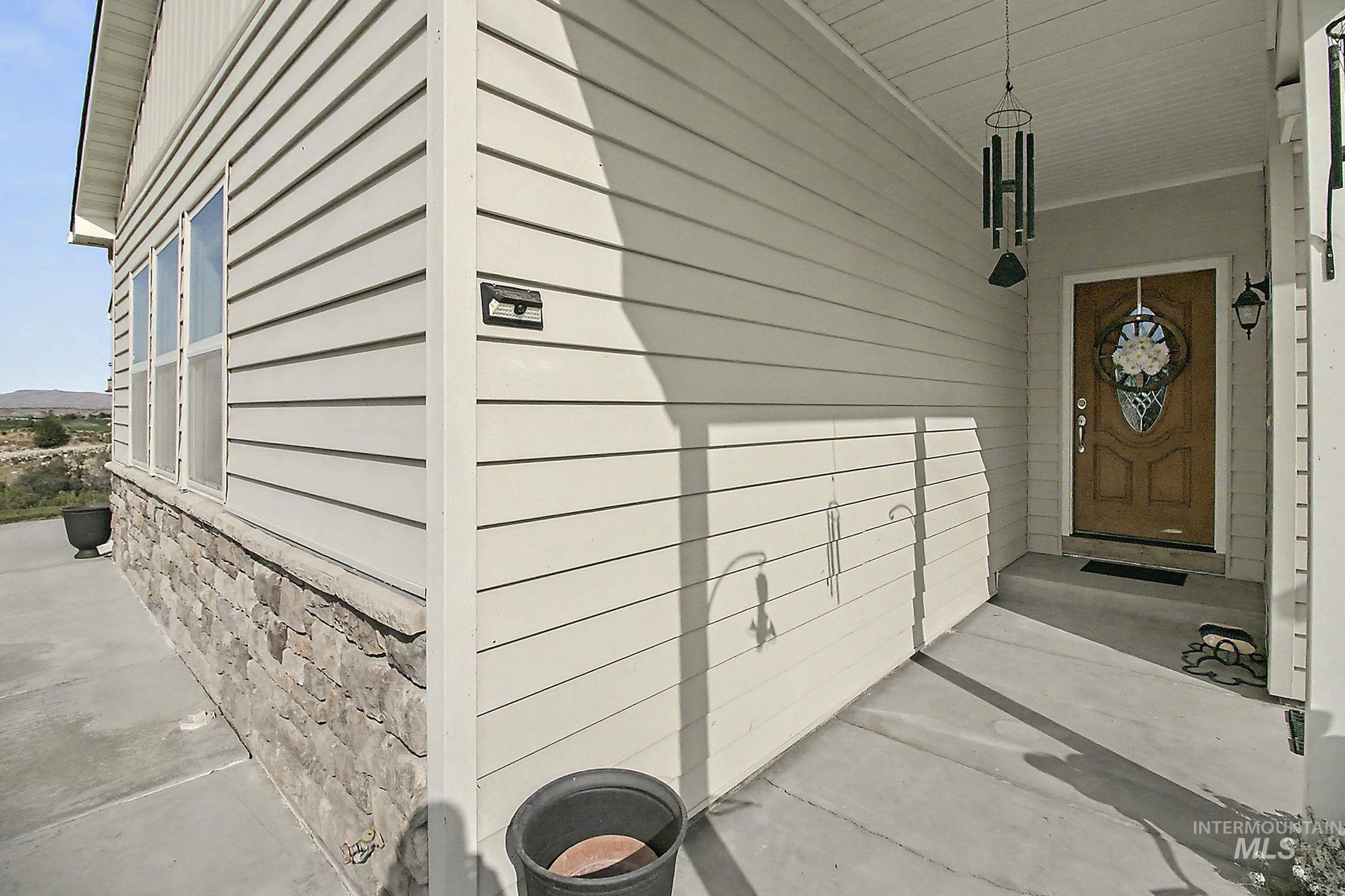 6900 West Charters Lane Melba, ID 83641 - Photo 6 of 49 Siding exterior with a stone veneer foundation