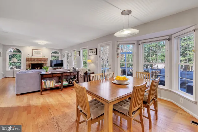a living room with furniture fireplace and a large window