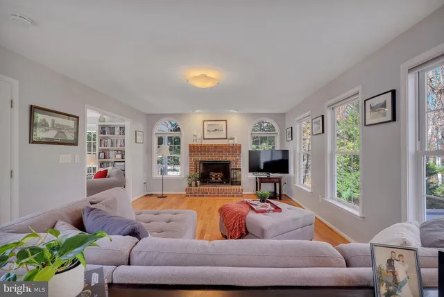 a living room with furniture a window and a fireplace