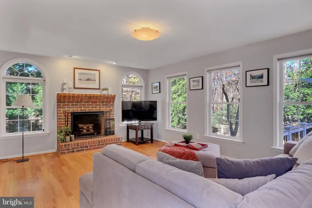 a view of a dining room with furniture a chandelier and wooden floor