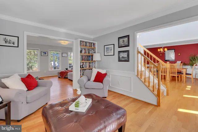 a living room with furniture and a book shelf