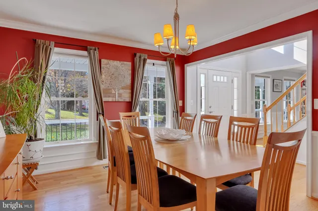 a view of a dining room with furniture a chandelier and wooden floor