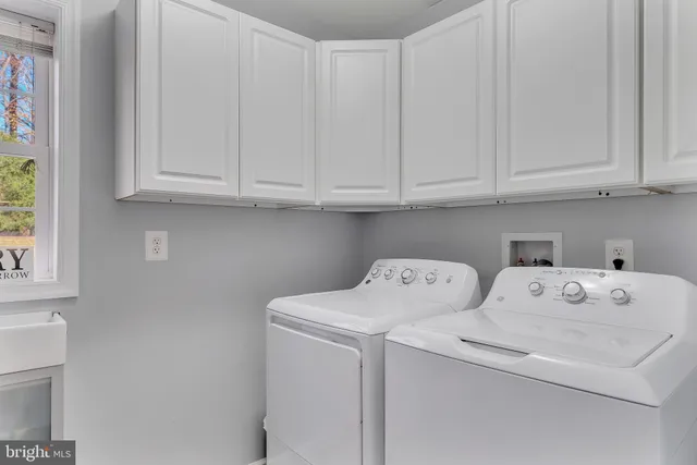 a spacious bedroom with a bed and a chandelier