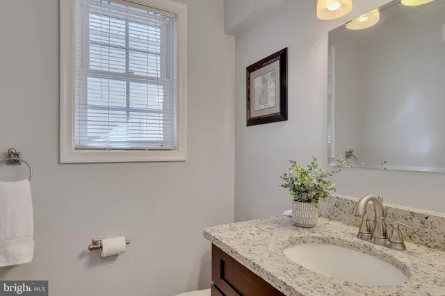 a bathroom with a tub a sink and a window
