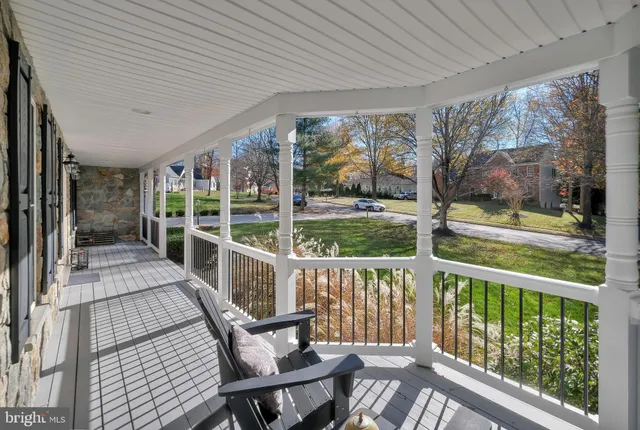a patio with glass top table and chairs