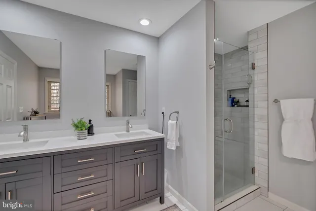 a bathroom with a double vanity sink and a mirror