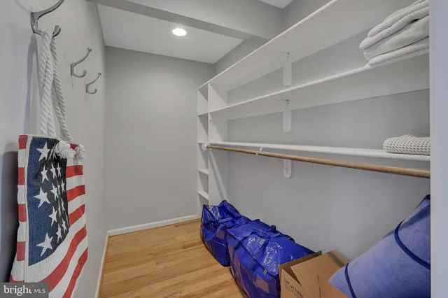 a roof deck with couches and wooden floor