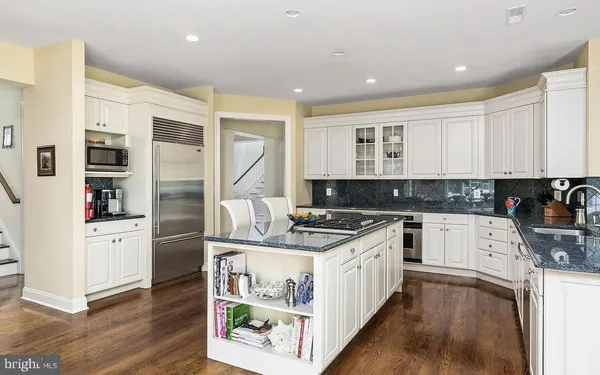 a kitchen with stainless steel appliances granite countertop a stove and a sink